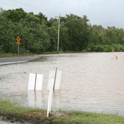 Flooded road with partially submerged road signs 